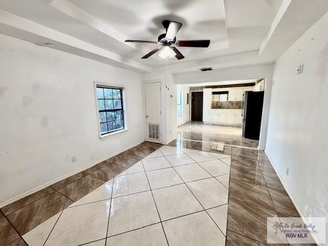 2413 Eastern Blvd, Brownsville, TX 78520 - spare room with a tray ceiling, ceiling fan, and baseboards