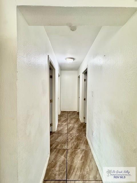 2413 Eastern Blvd, Brownsville, TX 78520 - hallway featuring baseboards and tile patterned flooring