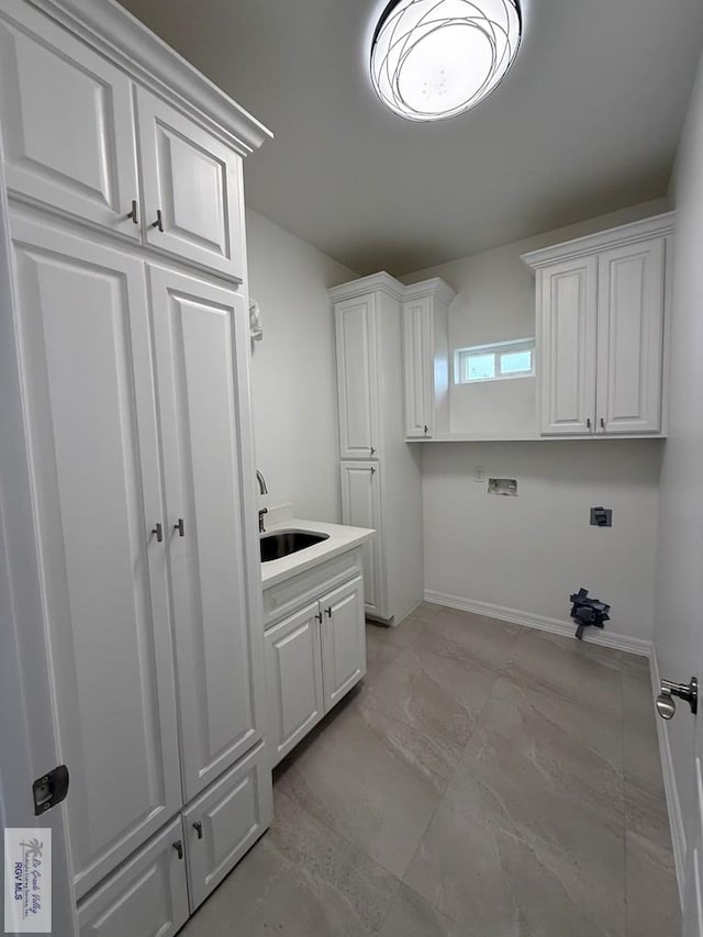 139 Heron Dr, Los Fresnos, TX 78566 - washroom with washer hookup, cabinet space, electric dryer hookup, and light marble finish floors