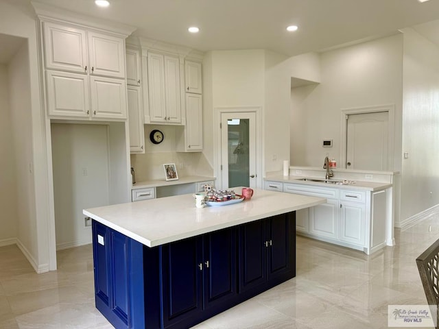 139 Heron Dr, Los Fresnos, TX 78566 - kitchen featuring light countertops, white cabinetry, a kitchen island, and recessed lighting