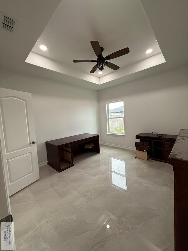 139 Heron Dr, Los Fresnos, TX 78566 - office space with a tray ceiling, ceiling fan, recessed lighting, and light marble finish floors