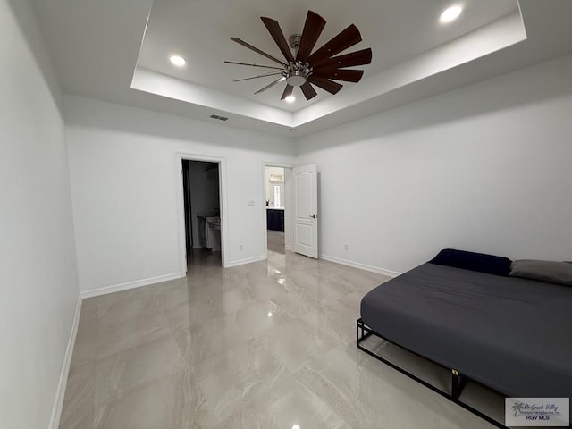 139 Heron Dr, Los Fresnos, TX 78566 - bedroom with a tray ceiling, recessed lighting, light marble finish flooring, and ensuite bathroom