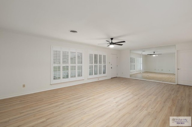 unfurnished living room with light wood-type flooring, plenty of natural light, crown molding, and ceiling fan