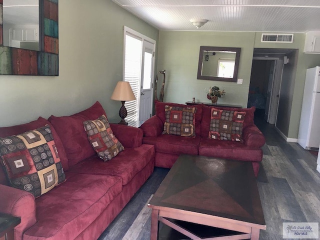 living room with dark hardwood / wood-style flooring