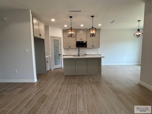 kitchen featuring visible vents, recessed lighting, wood finished floors, baseboards, and black microwave