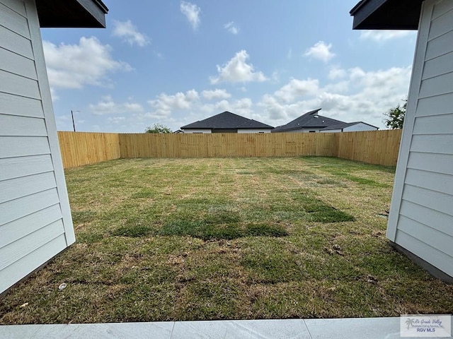 view of yard with a fenced backyard