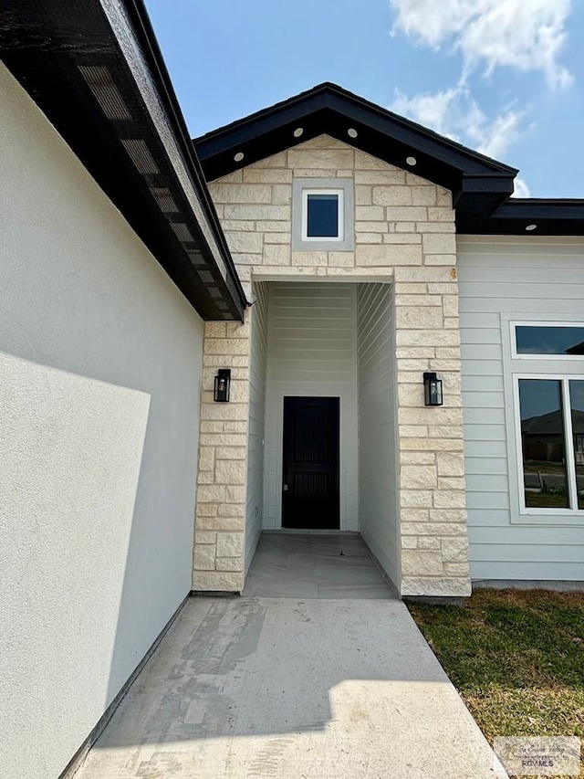doorway to property featuring stone siding