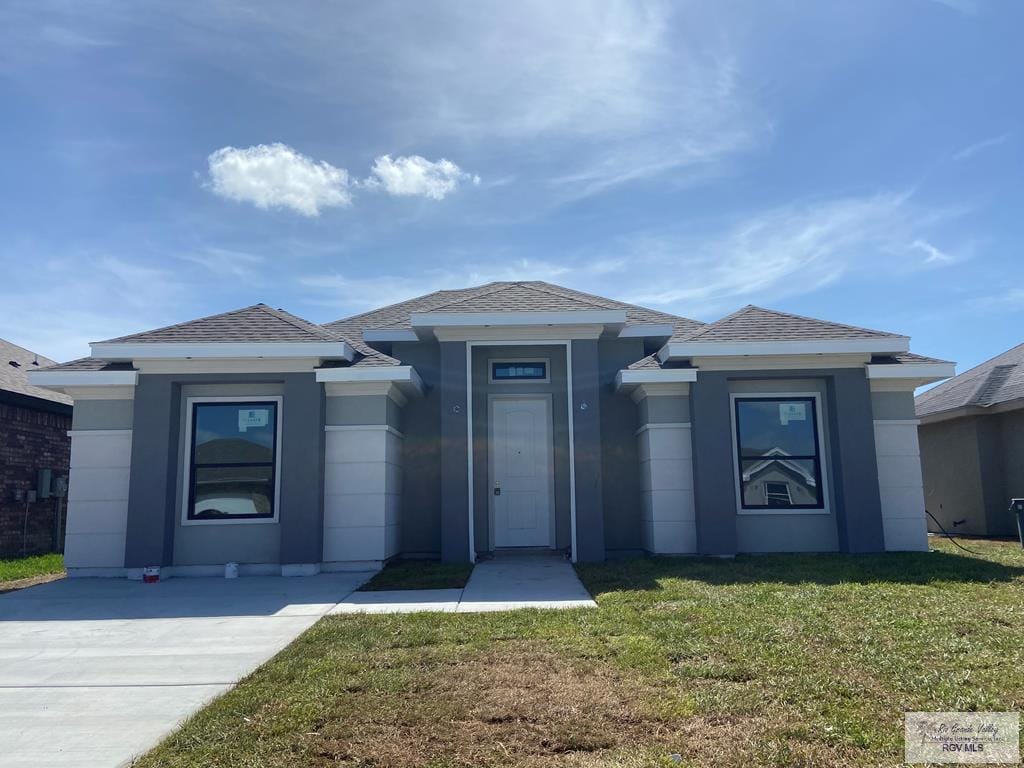 37811 Vineyard Ave, Brownsville, TX 78520 - prairie-style house featuring a front yard and a shingled roof