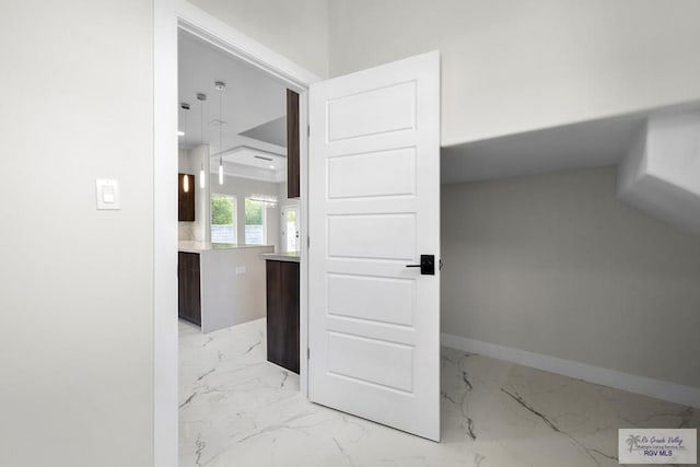 1013 Butler St, Edinburg, TX 78541 - corridor featuring light marble finish flooring and baseboards