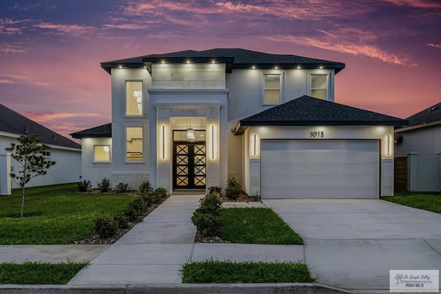 1013 Butler St, Edinburg, TX 78541 - view of front of home with an attached garage, a lawn, stucco siding, concrete driveway, and roof with shingles