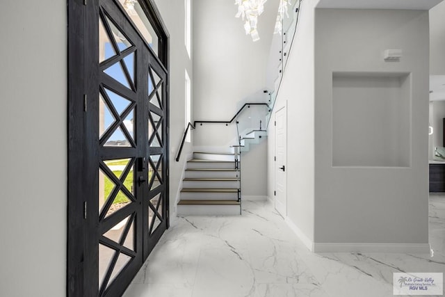 1013 Butler St, Edinburg, TX 78541 - entrance foyer featuring marble tiled flooring, baseboards, and stairway