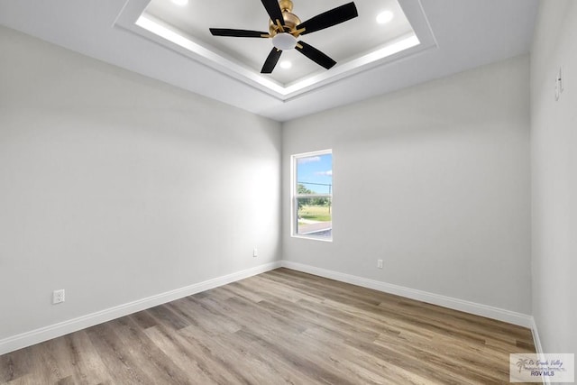 1013 Butler St, Edinburg, TX 78541 - unfurnished room with a ceiling fan, a raised ceiling, light wood-style flooring, and recessed lighting