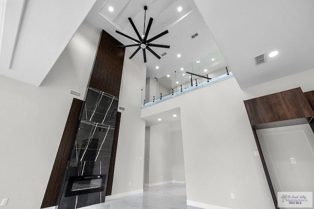 1013 Butler St, Edinburg, TX 78541 - unfurnished living room with a ceiling fan, a towering ceiling, recessed lighting, marble finish flooring, and baseboards