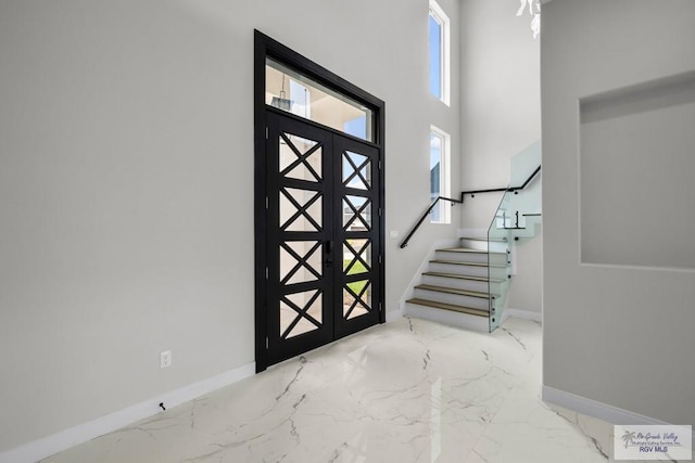 1013 Butler St, Edinburg, TX 78541 - entrance foyer featuring marble tiled flooring, baseboards, and stairs