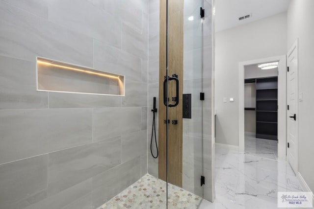 1013 Butler St, Edinburg, TX 78541 - bathroom with a stall shower, marble finish floors, and baseboards