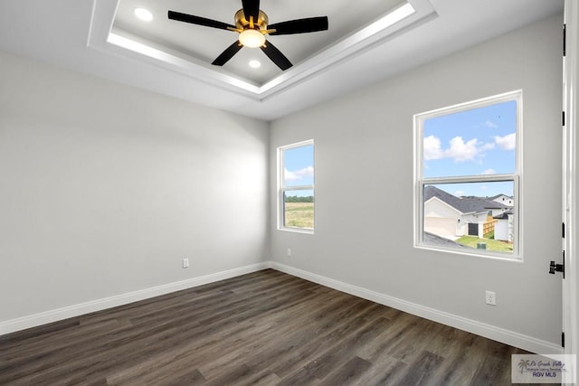 1013 Butler St, Edinburg, TX 78541 - spare room with dark wood-style flooring, baseboards, a tray ceiling, ceiling fan, and recessed lighting