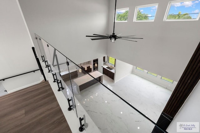 1013 Butler St, Edinburg, TX 78541 - stairs featuring a ceiling fan, healthy amount of natural light, wood finished floors, and baseboards