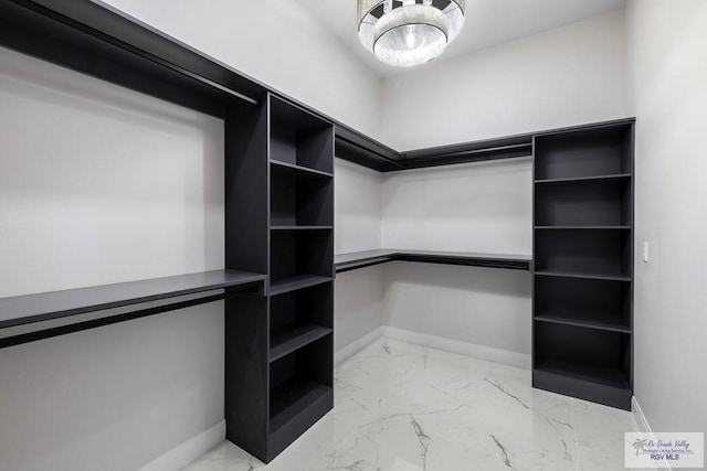 1013 Butler St, Edinburg, TX 78541 - spacious closet featuring light marble finish floors and a chandelier