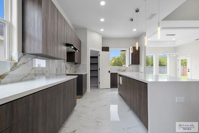 1013 Butler St, Edinburg, TX 78541 - kitchen featuring modern cabinets, recessed lighting, tasteful backsplash, light marble finish flooring, and light countertops