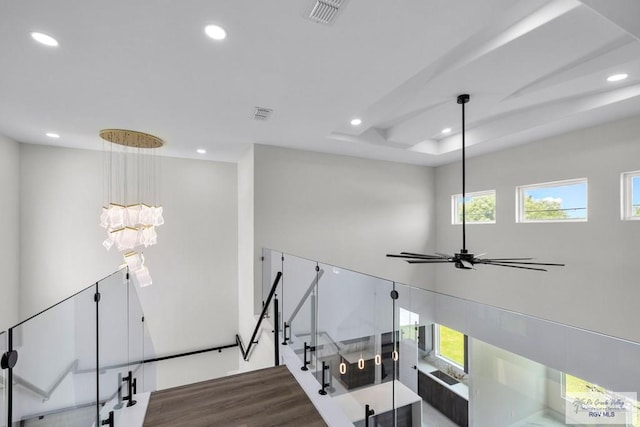 1013 Butler St, Edinburg, TX 78541 - stairs featuring recessed lighting, wood finished floors, healthy amount of natural light, a tray ceiling, and a chandelier