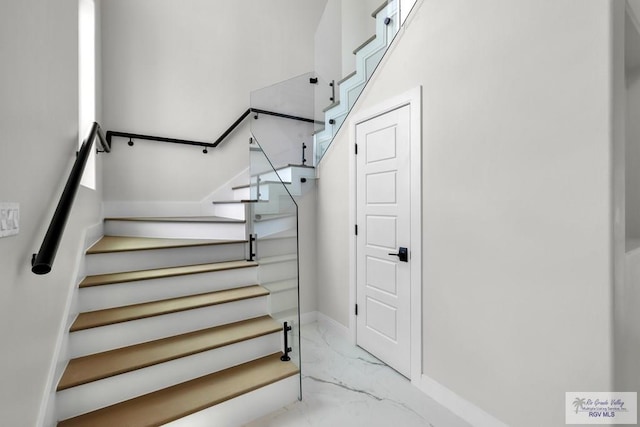 1013 Butler St, Edinburg, TX 78541 - stairway featuring marble look tile flooring and baseboards