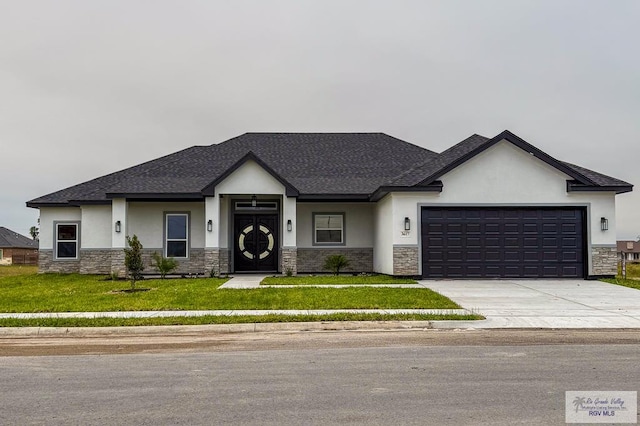 view of front of house with a front yard and a garage