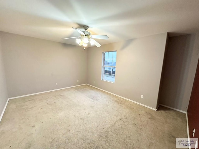 unfurnished room with carpet floors, a ceiling fan, and baseboards