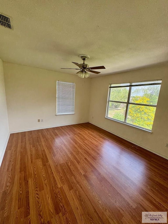 2100 Emory Ave Unit 291, Mcallen, TX 78504 - unfurnished room featuring wood finished floors, a textured ceiling, a ceiling fan, and baseboards