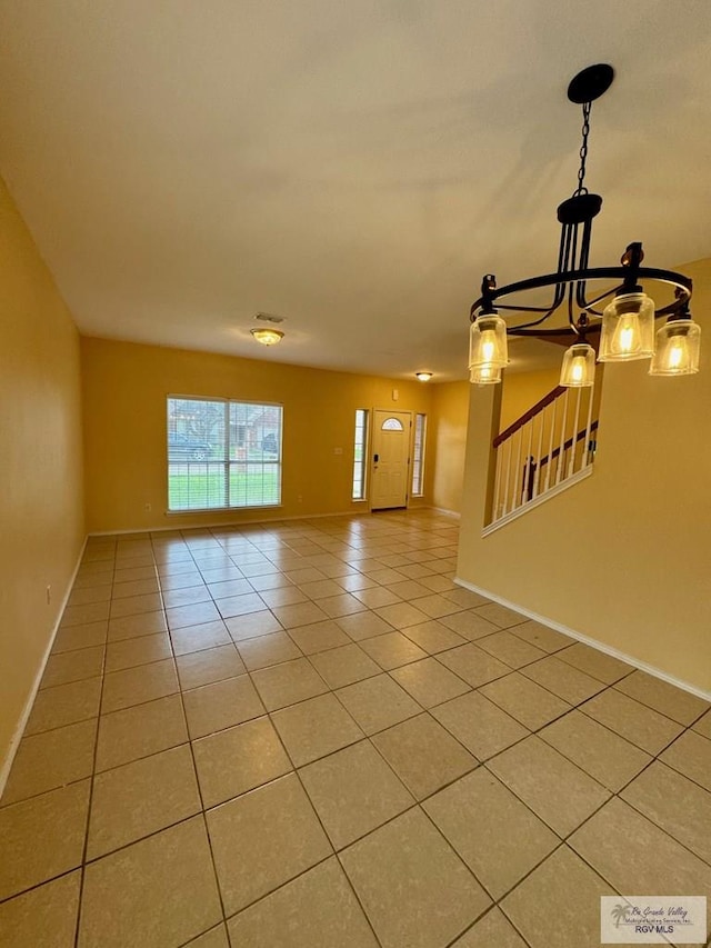 2100 Emory Ave Unit 291, Mcallen, TX 78504 - unfurnished living room featuring light tile patterned floors, baseboards, and a chandelier