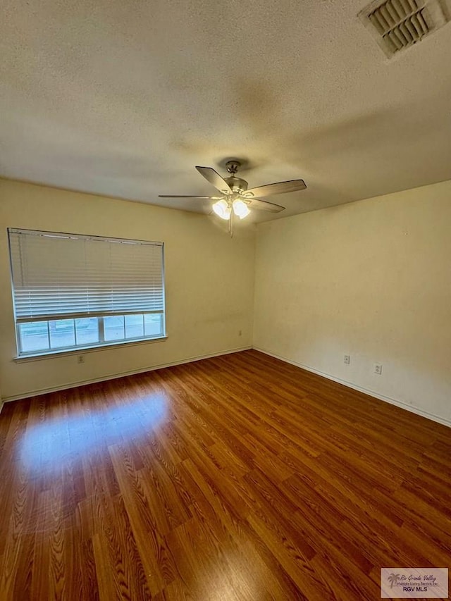 2100 Emory Ave Unit 291, Mcallen, TX 78504 - spare room featuring a textured ceiling, wood finished floors, ceiling fan, and baseboards