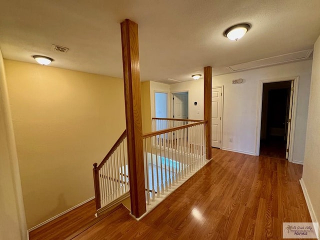 2100 Emory Ave Unit 291, Mcallen, TX 78504 - hallway featuring an upstairs landing, wood finished floors, baseboards, and attic access