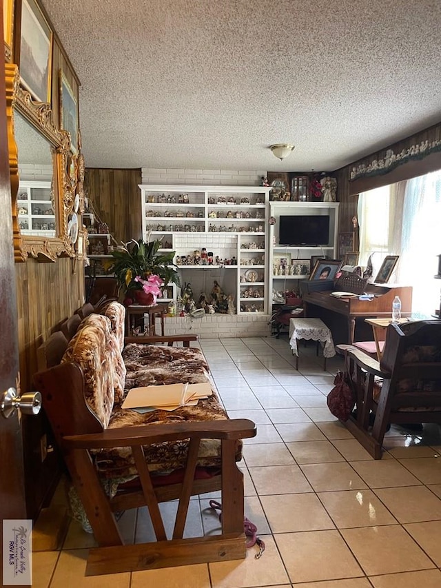 103 Alan A Dale St, Brownsville, TX 78521 - tiled living room featuring a textured ceiling and wooden walls