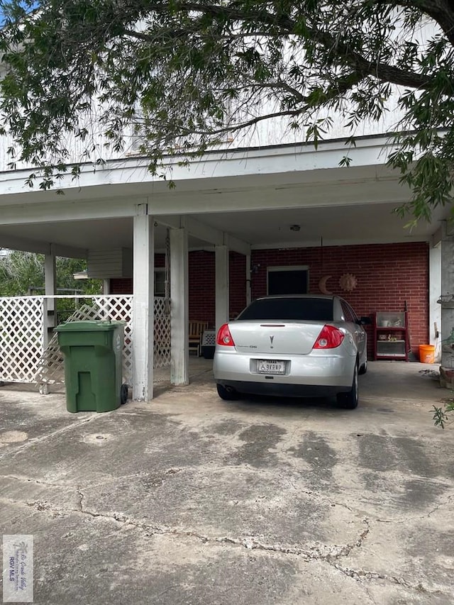 103 Alan A Dale St, Brownsville, TX 78521 - view of parking featuring an attached carport and concrete driveway