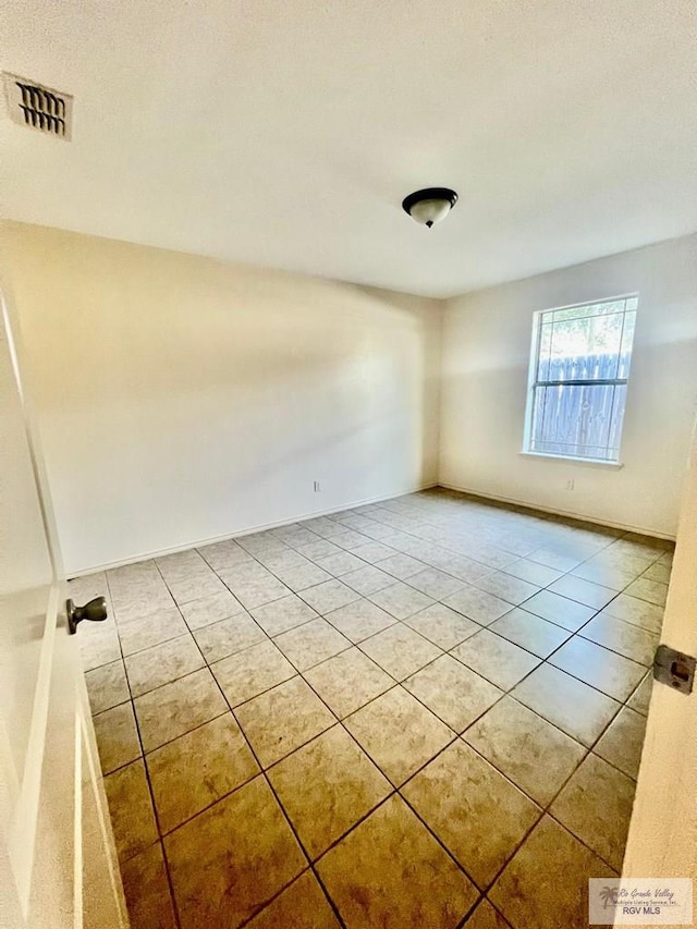 spare room with tile patterned flooring