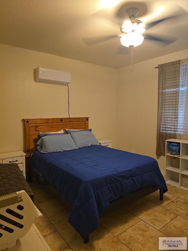 bedroom with a wall mounted air conditioner and ceiling fan
