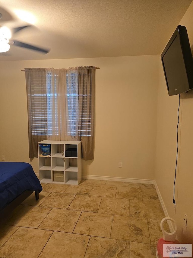bedroom with baseboards and a ceiling fan