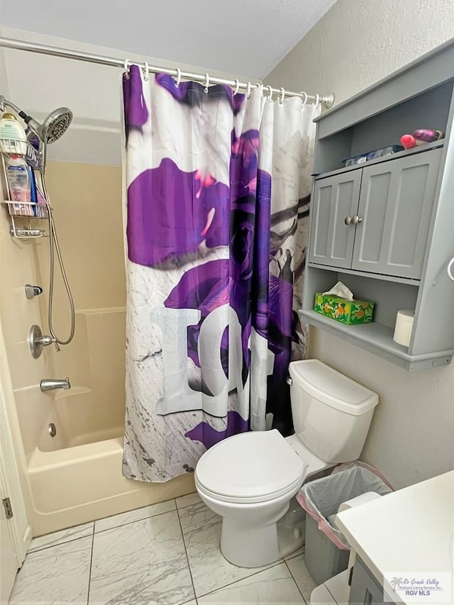 full bathroom with vanity, shower / tub combo, and toilet