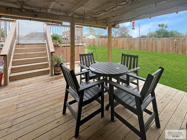 wooden deck featuring a yard