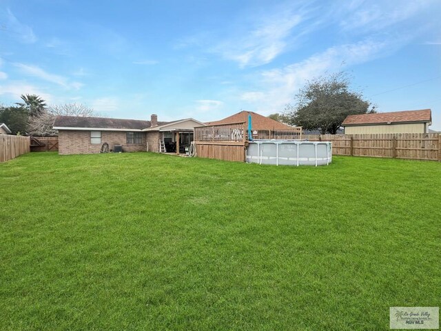 view of yard with a fenced in pool