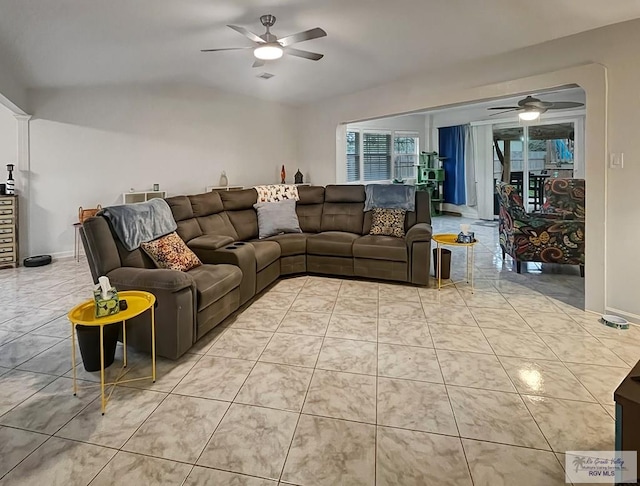 tiled living room featuring vaulted ceiling and ceiling fan