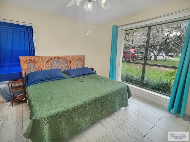 bedroom with multiple windows and ceiling fan