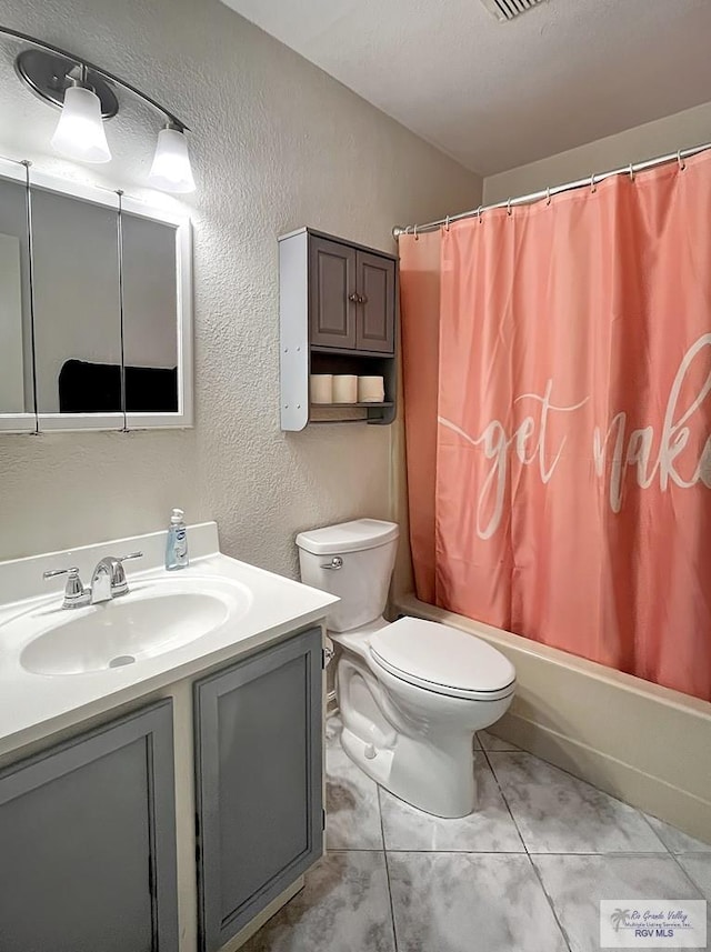 full bathroom featuring shower / bath combination with curtain, vanity, tile patterned floors, and toilet