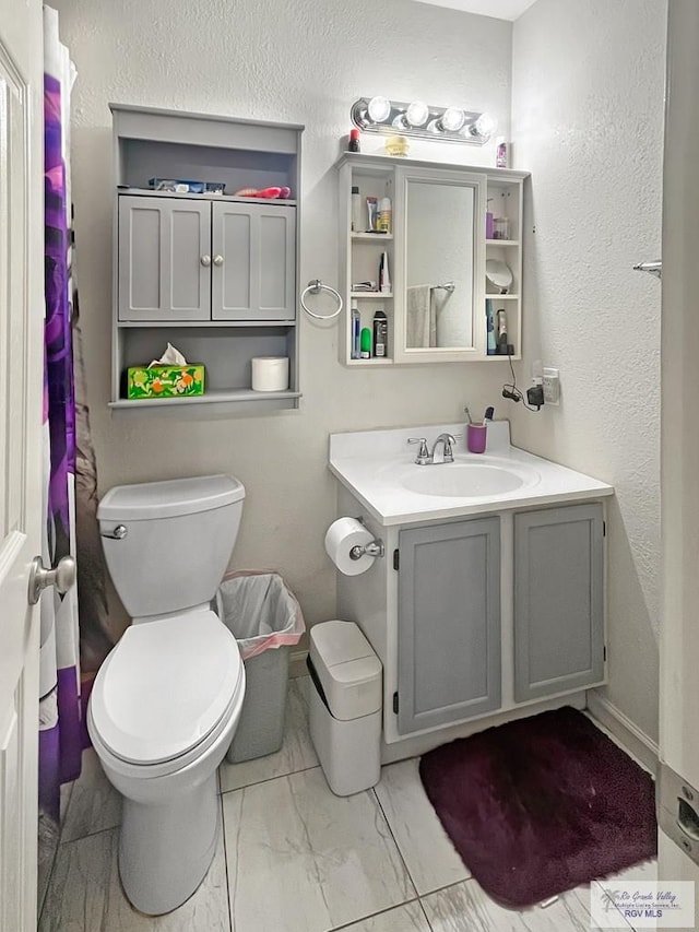 bathroom featuring vanity and toilet