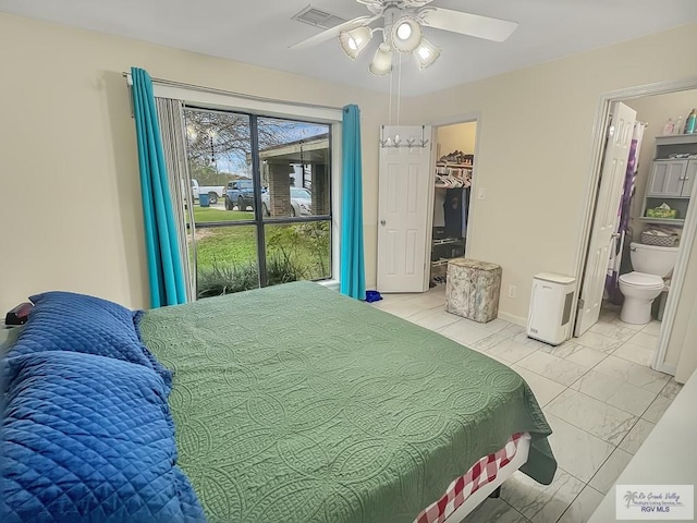 bedroom featuring a spacious closet, ceiling fan, and ensuite bathroom