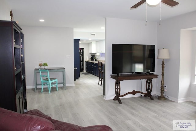 living room with ceiling fan and light hardwood / wood-style floors