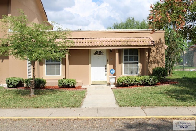 2402 Ed Carey Dr Unit 6, Harlingen, TX 78550 - view of front of property featuring stucco siding and a front yard