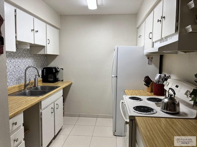 2 Palmetto Ct, Brownsville, TX 78521 - kitchen with electric range, a sink, under cabinet range hood, light tile patterned floors, and light countertops