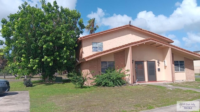 2 Palmetto Ct, Brownsville, TX 78521 - view of front of house featuring a front lawn and brick siding