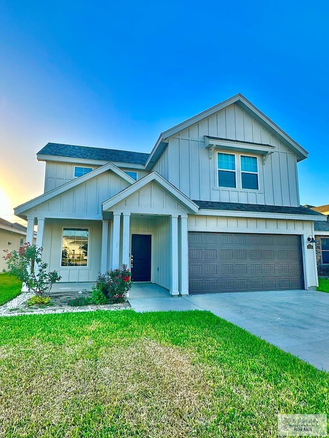 view of front of house with a garage and a lawn