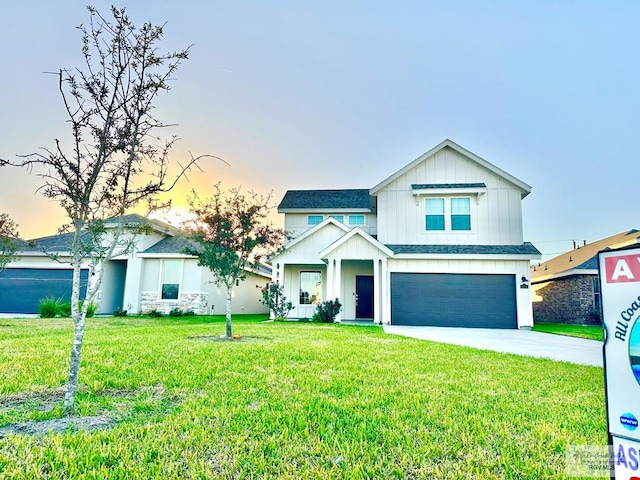 view of front of property with a garage and a lawn